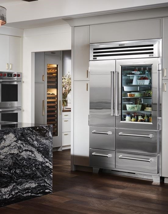 Sub-Zero 48 inch Pro Refrigerator and Freezer with Glass Door displayed in a custom kitchen design featuring large marble kitchen island