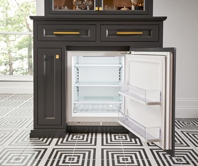 Interior view of Sub-Zero 24" Designer Undercounter ADA Height Refrigerator - Panel Ready (DEU2450R/ADA) integrated with black custom cabinetry