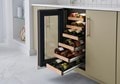 Side view of Sub-Zero 15" Designer Undercounter Wine Storage - Panel Ready (DEU1550W) with wine racks extended at increasing lengths from top to bottom