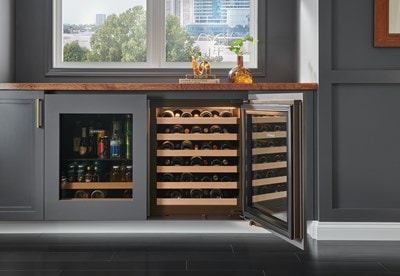 Sub-Zero 24" Designer Undercounter ADA Height Wine Storage - Panel Ready (DEU2450W/ADA) with six wood bordered shelves shown in black custom cabinetry