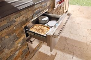 Wolf 30" Outdoor Warming Drawer (WWD30O) shown in a gourmet outdoor cooking area featuring best in quality Wolf cooking appliances