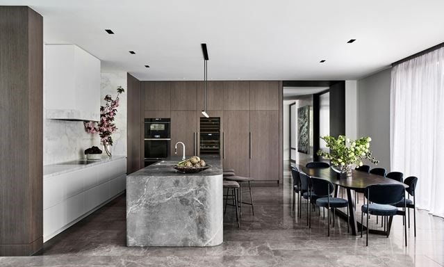 The Lumiere Penthouse kitchen design featuring Sub-Zero Refrigeration blending seamlessly into smooth minimalist cabinetry 