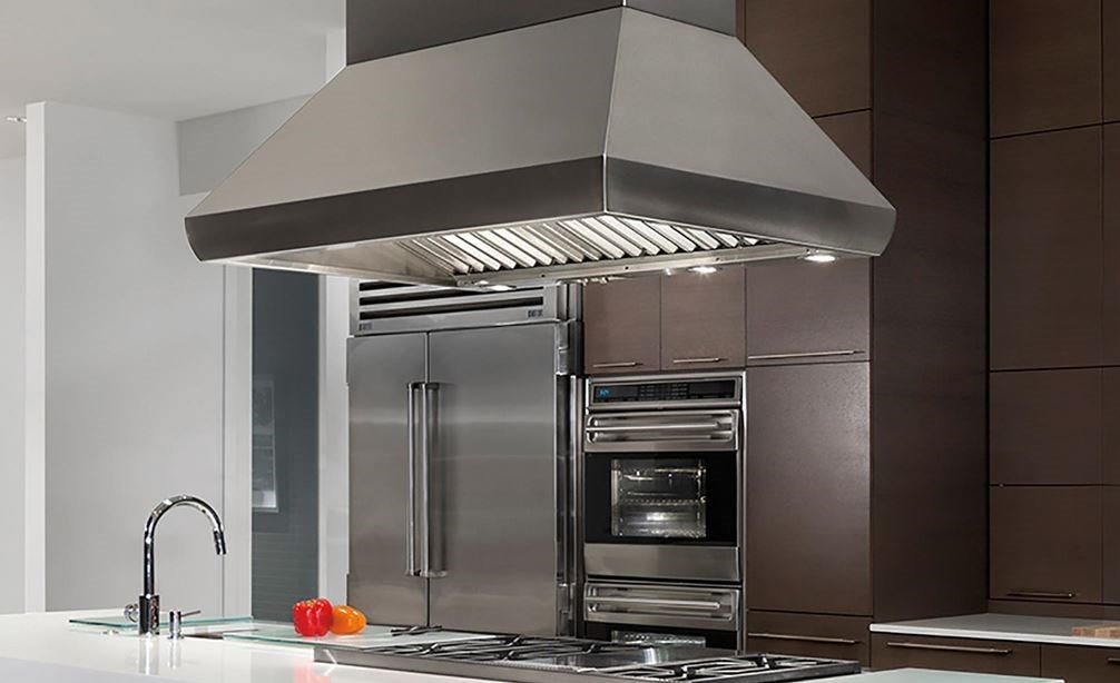 The Wolf 54&quot; Pro Island Hood (PI543418) displayed above 48&quot; Sealed Burner Rangetop (SRT486G) in large ultra-modern panel kitchen design