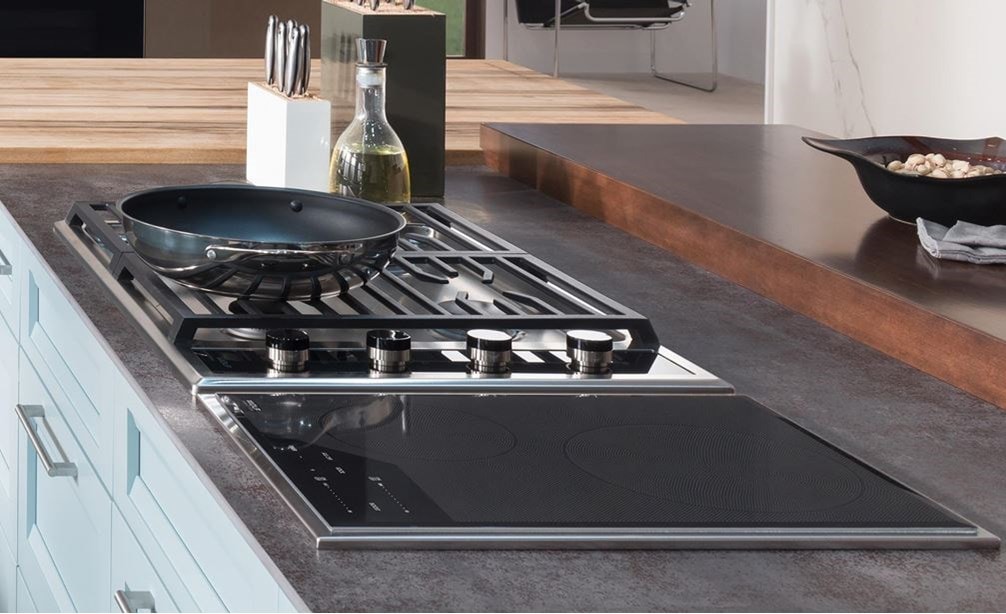The Wolf 15&quot; Transitional Induction Cooktop (CI152TF/S) shown with Wolf 45&quot; Cooktop Island Hood - Glass (VI45G) in large open kitchen
