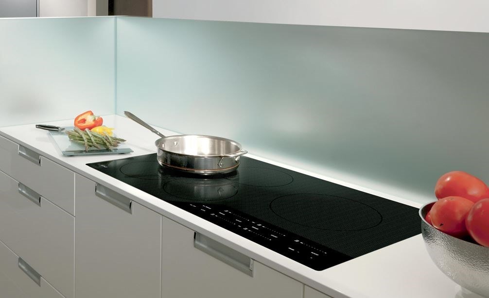 Wolf 36&quot; Contemporary Induction Cooktop (CI365C/B) shown with 36&quot; Cooktop Wall Hood Black (VW36B) shines in clean seamless kitchen design