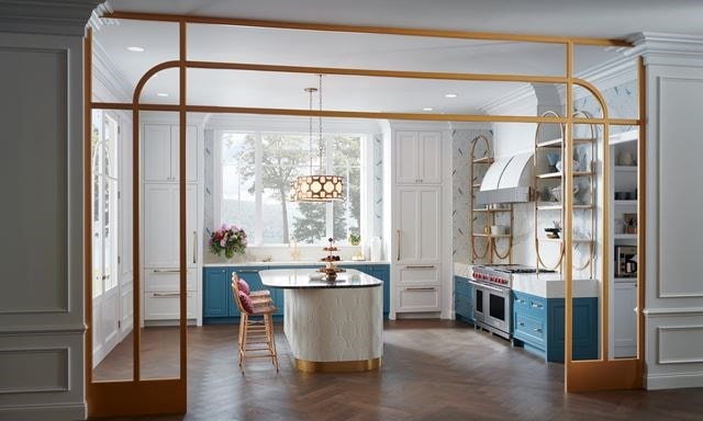 Wolf Appliances featured in a whimsical custom kitchen design showcasing open shelves, gold fixtures and white marble countertops