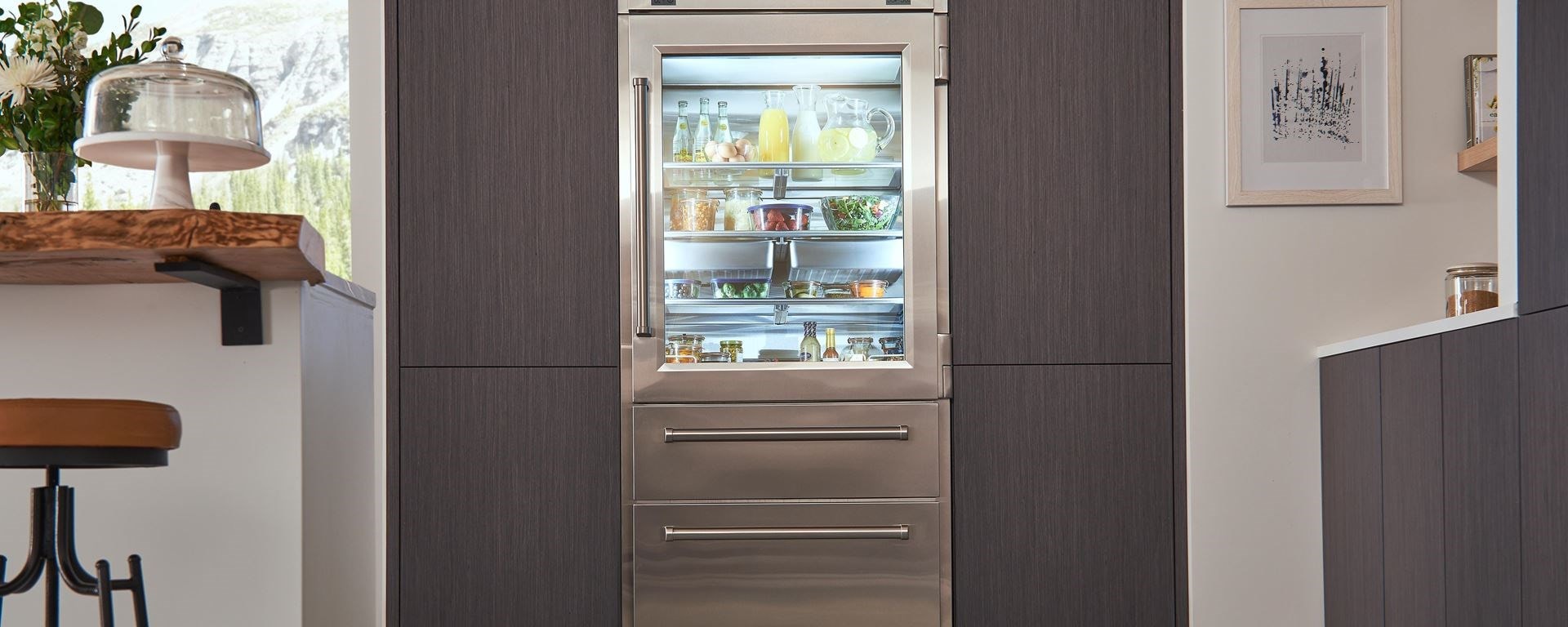 Sub-Zero Pro Glass Door Refrigerator Freezer set in seamless wood grain kitchen cabinets