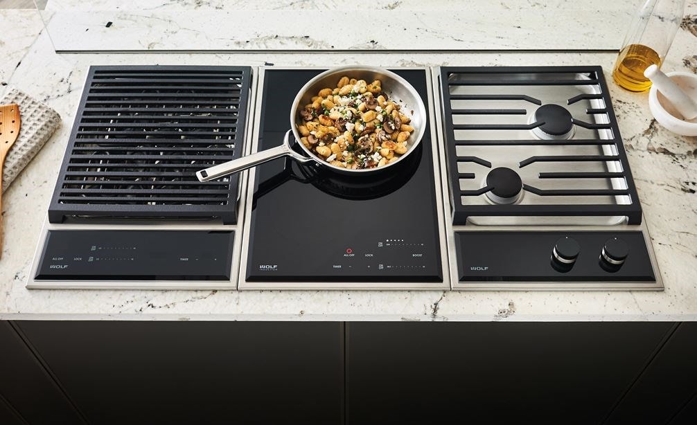 The Wolf 15&quot; Transitional Framed Gas Cooktop (CG152TF/S) featured in a rich array of textures including sleek countertops
