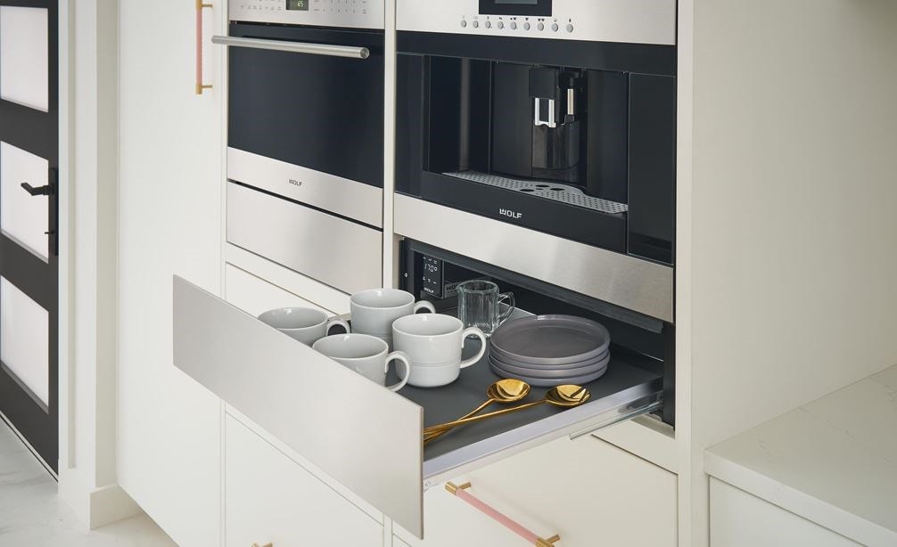 The Wolf 24&amp;quot; Cup Warming Drawer Stainless Steel (CW24/S) shown paired with the Wolf 24&amp;quot; Coffee System Stainless Steel (EC24/S)