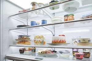 Sub-Zero Classic Series Full Size Refrigerator with propped 48 inch French Door displaying four levels of gleaming fresh food shelving.