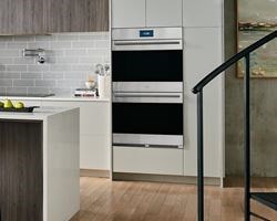 Wolf Dual Wall Ovens featured in an open and spacious luxury kitchen design.