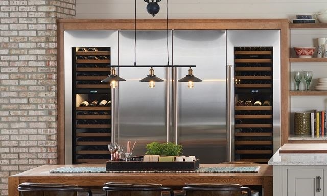 Nordic farmhouse kitchen design featuring Sub-Zero Designer Series Refrigerator and Wine Storage unit with Wolf Induction Range, Microwave Oven and Ventilation Hood