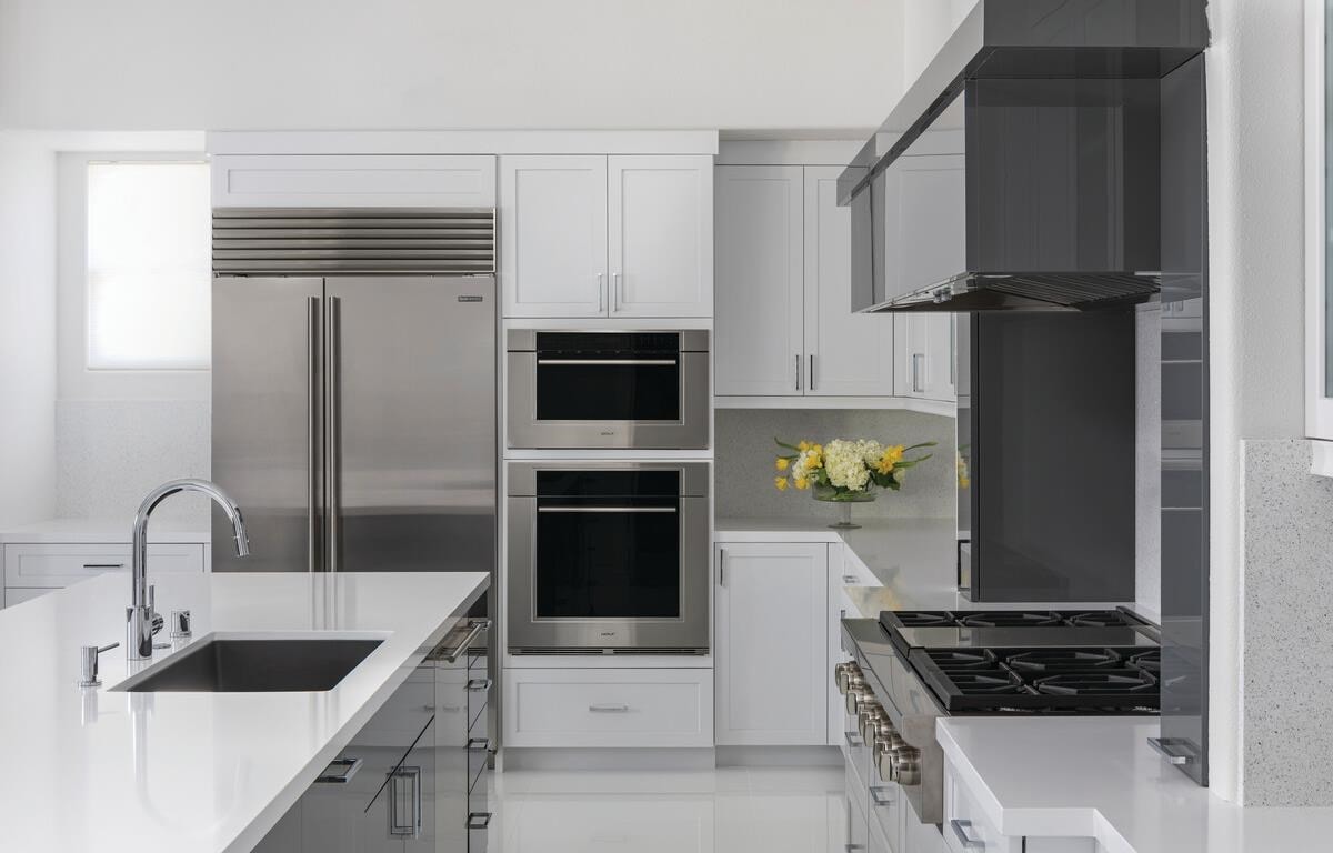 Clean, minimalist kitchen design featuring Sub-Zero Classic Series Refrigerator, Cove Dishwasher, Wolf M Series Oven, Sealed Burner Rangetop and Wolf Speed Oven