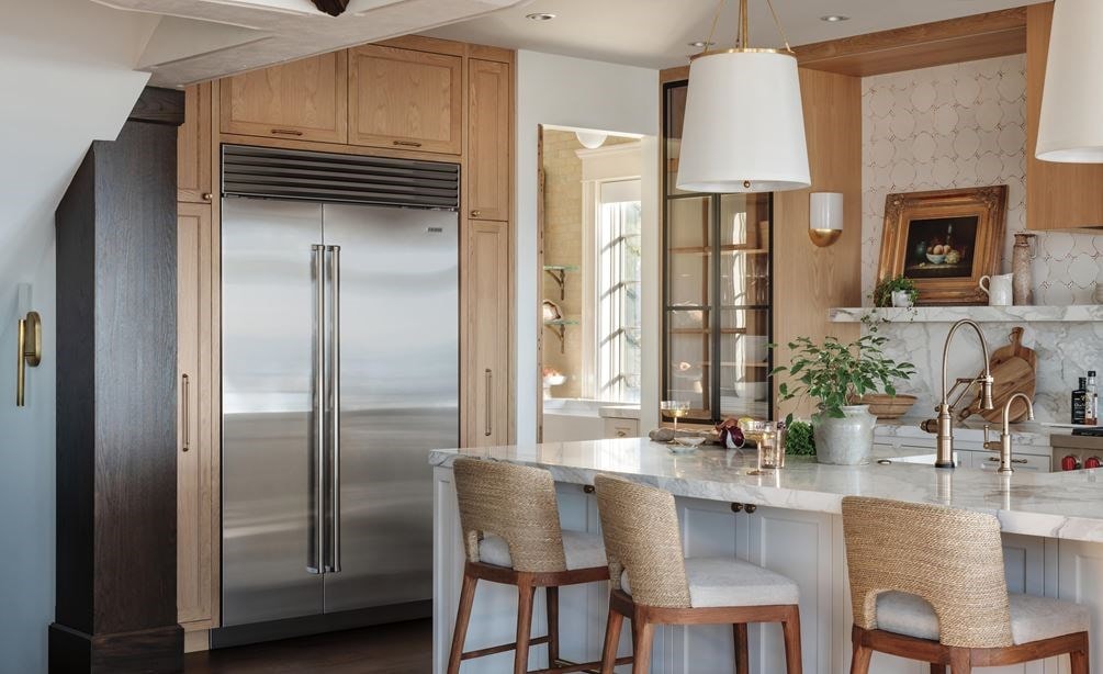 Stainless Steel Sub-Zero 48 Inch Classic Side-by-Side Refrigerator Freezer featured in a light and open custom kitchen design featuring soft wood tones