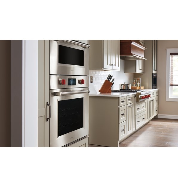 Sub-Zero 30" Designer Over and Under Refrigerator Freezer with Ice Maker and Internal Dispenser shown Panel Ready in a clean and crisp kitchen design. 