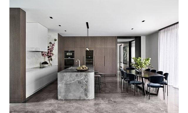 White backsplash, light gray island, and darker gray floors in NNH Residence by Miriam Fanning.