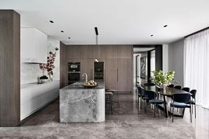 White backsplash, light gray island, and darker gray floors in NNH Residence by Miriam Fanning.