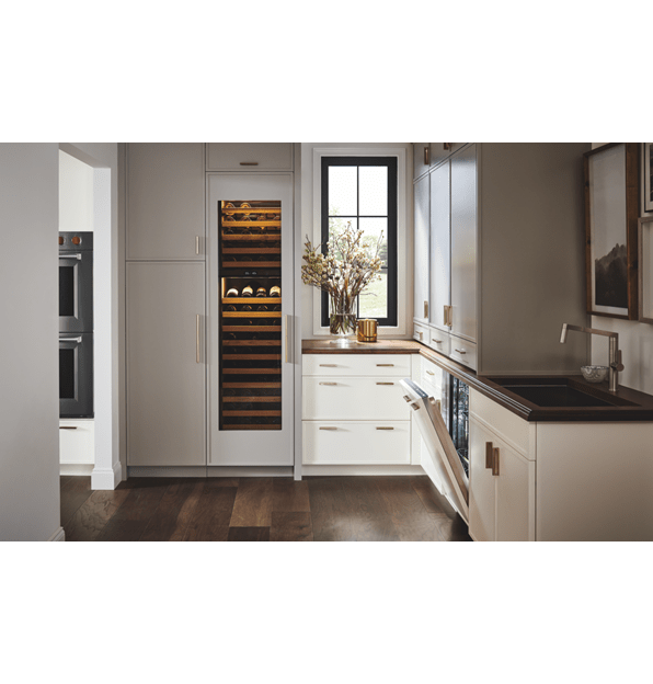 Panel ready Cove Dishwasher shown in a custom kitchen design featuring dual Wolf Ovens and Sub-Zero Wine Storage