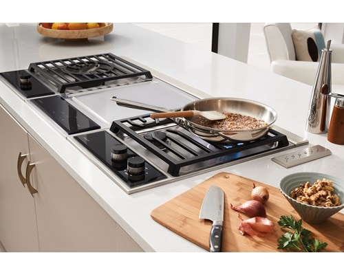 Wolf 15" transitional gas cooktop module (CG152TFS) paired with a 15" transitional teppanyaki module (TM15TFS) and 15" transitional multifunction module (MM15TFS)