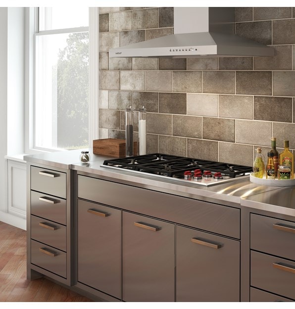 The Wolf 36" Professional Gas Cooktop (CG365P/S) and 36" Cooktop Wall Hood - Stainless (VW36S) displayed in an elegant kitchen design