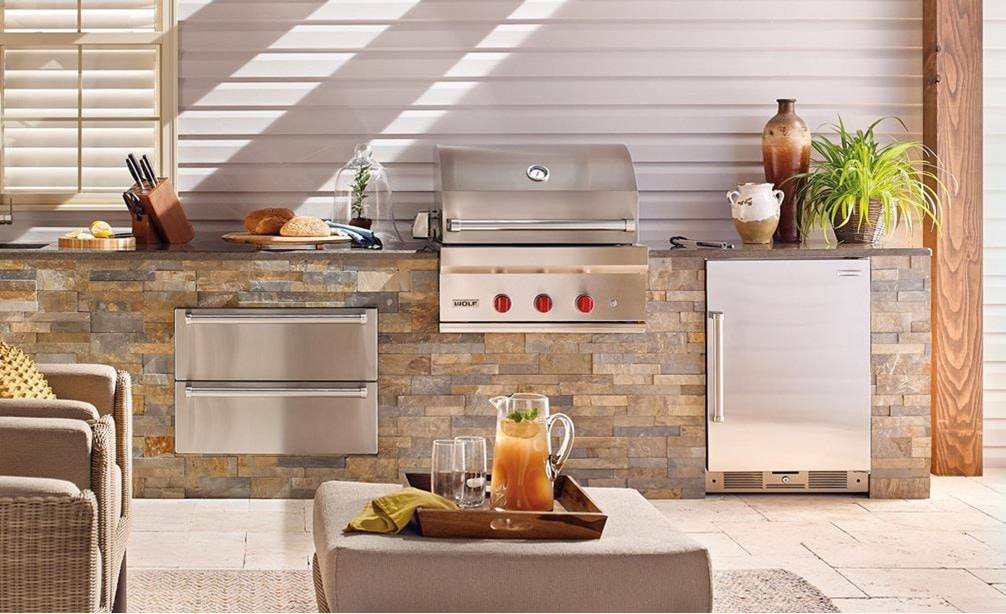 The Wolf 30&quot; Outdoor Gas Grill (OG30) shown with Wolf 30&quot; Outdoor Warming Drawer (WWD30O) in a luxury outdoor kitchen space.