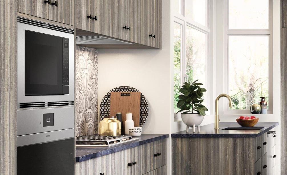 Wolf 24&quot; Standard Microwave Oven (MS24) shown in open rustic kitchen design featuring warm toned concrete floors and wood panel cabinetry