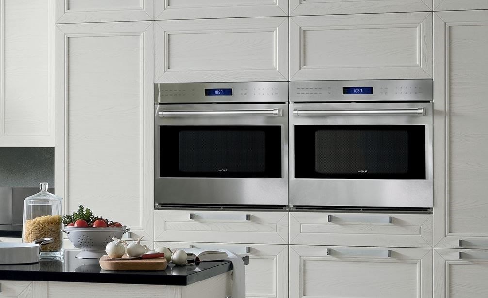 A Pair of Wolf 30&quot; E Series Professional Classic Single Ovens (SO30PE/S/PH) displayed expertly within clean kitchen cabinetry.