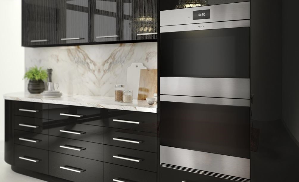 The Wolf 30&quot; M Series Contemporary Stainless Steel Double Oven (DO30CM/S) shown blending seamlessly into modern glossy kitchen cabinetry.