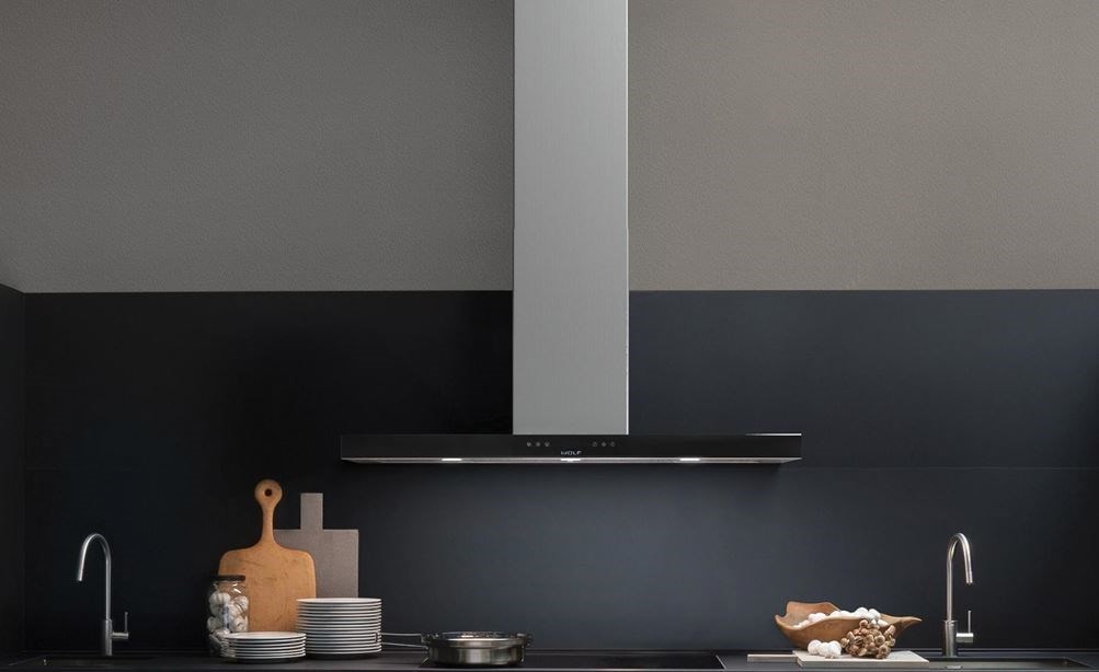 The Wolf 45&quot; Cooktop Wall Hood - Black (VW45B) shown blending seamlessly into a sleek dark tone contemporary room design.