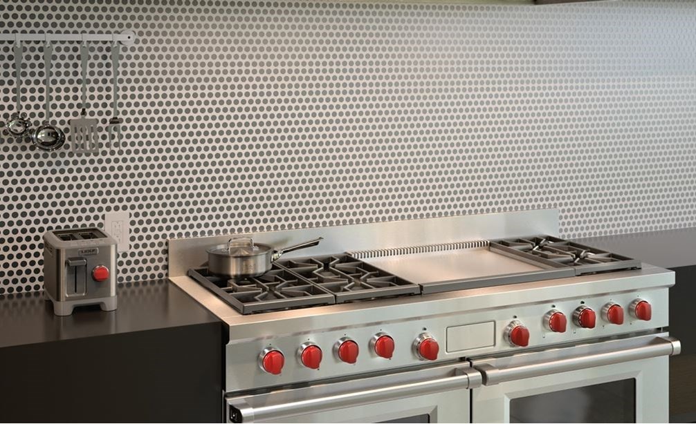 Wolf 60&quot; Dual Fuel Range 6 Burner Infrared Dual Griddle (DF606DG) shown with modern chrome backsplash centered between glossy countertops