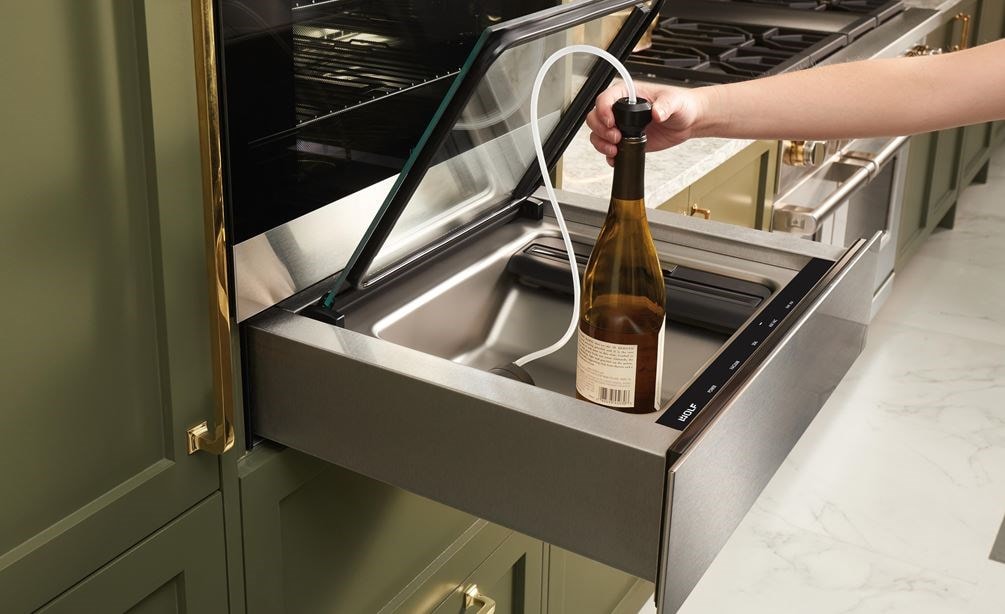 The Wolf 24&quot; Vacuum Seal Drawer (VS24) shown protecting and prolonging the life of uncorked wine using the attachment provided 