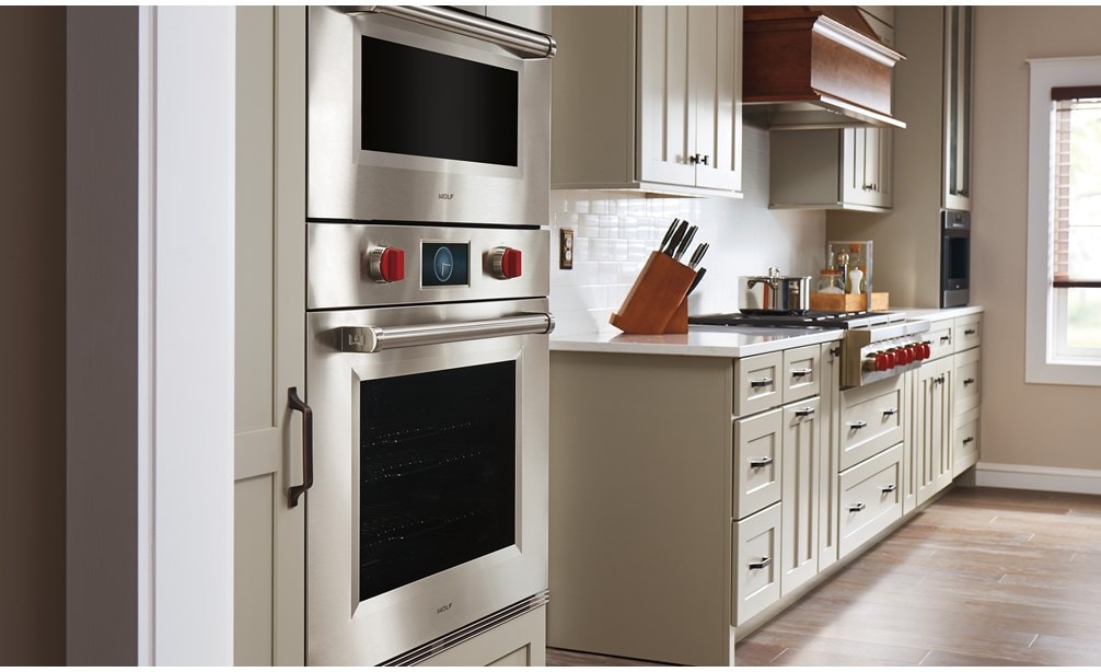 Sub-Zero 30" Designer Over and Under Refrigerator Freezer with Ice Maker and Internal Dispenser shown Panel Ready in a clean and crisp kitchen design. 