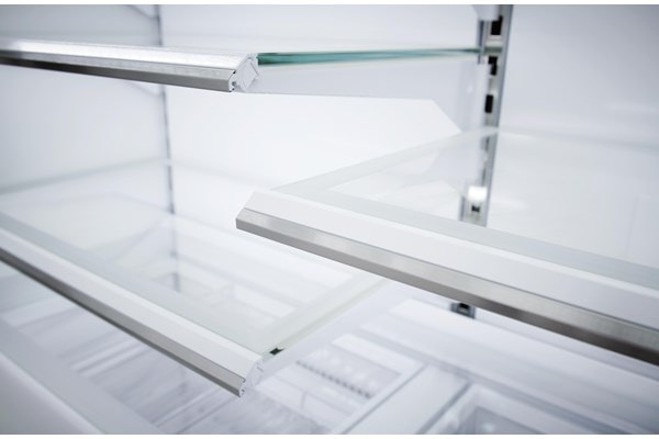 Close up view of Sub-Zero Classic Series Full Size Refrigerator's LED lit  custom shelves