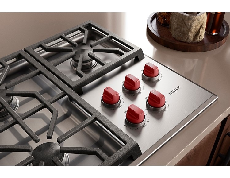Wolf M Series 36 inch Gas Cooktop (Professional) shown with premium grade stainless steel and iconic red knobs.