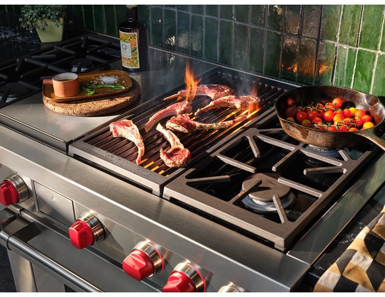 Wolf 48" Dual Fuel Range 4 Burner Infrared Charbroil Griddle (DF48450CG/S/P) shown in action searing meat and sauteing vegetables with finesse.