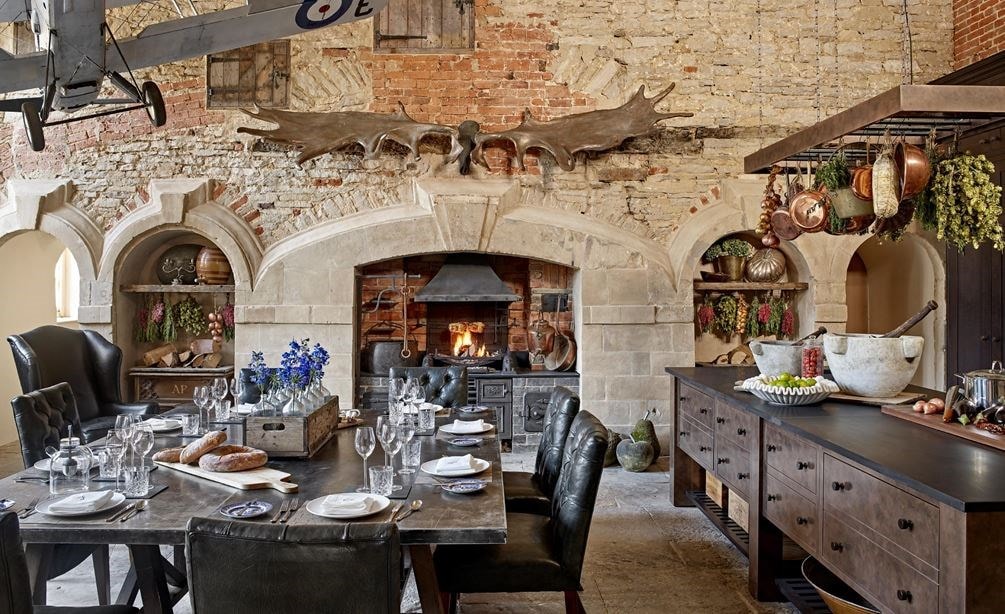 The original stone walls and flagstone floors were restored influencing Naomi Peters design for Cotswold Stately Home.