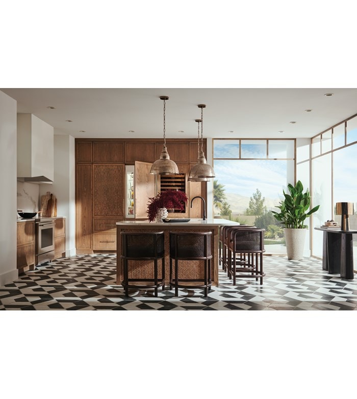 Panel Ready Sub-Zero 30 Inch Freezer Column with Ice Maker paired with Sub-Zero 30 Inch Tall Refrigerator with Internal Dispenser shown in a modern bright and open custom kitchen design