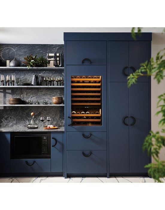 Sub-Zero 30 Inch Wine Column for High Altitude shown set flush within a custom midnight blue butler's pantry outfitted with rod iron handles