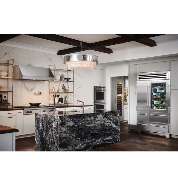 Sub-Zero 48 inch Pro Glass Door Refrigerator Freezer displayed in a large luxury rutic kitchen design featuring warm wood tone countertops and flooring