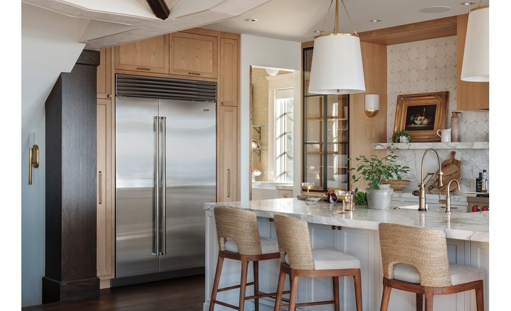 Stainless Steel Sub-Zero 48 Inch Classic Side-by-Side Refrigerator Freezer featured in a light and open custom kitchen design featuring soft wood tones