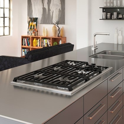 The Wolf 36" Transitional Gas Cooktop 5 Burners (CG365T/S) shown framed in clean lined stainless-steel countertop with polished accents