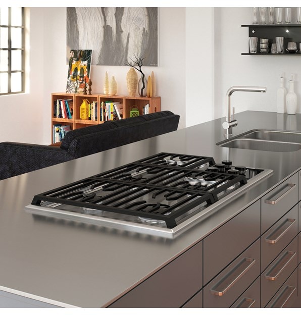 The Wolf 36" Transitional Gas Cooktop 5 Burners (CG365T/S) shown framed in clean lined stainless-steel countertop with polished accents