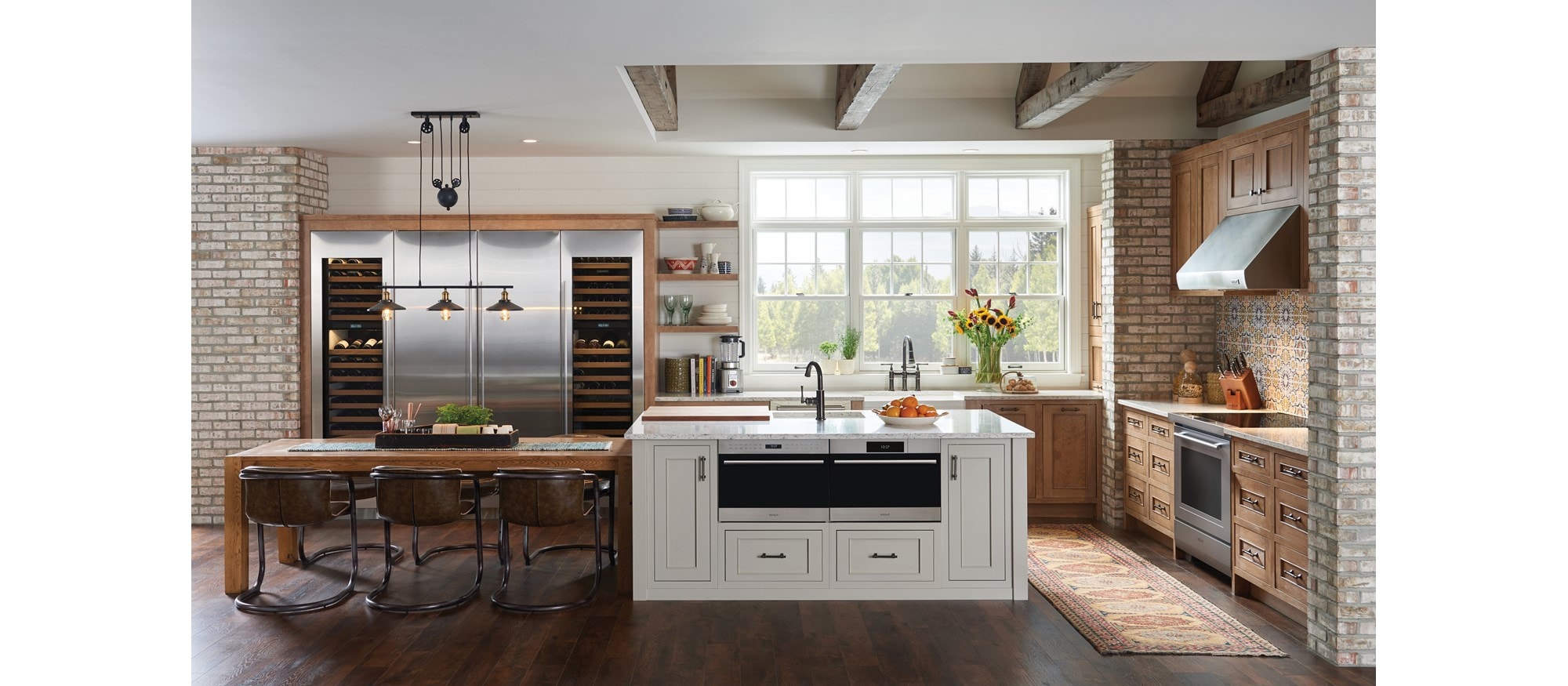 Wolf 24" E series Transitional Drop-Down Door Microwave Oven (MDD24TE/S/TH) shown set flush in large custom granite kitchen island