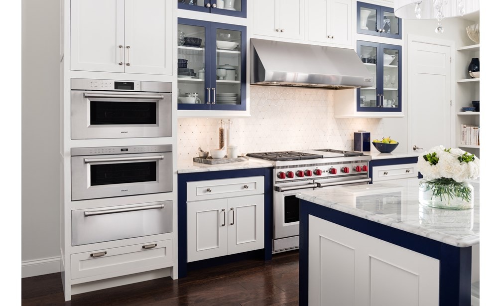 Wolf 30" M series Professional Drop-Down Door Microwave Oven (MDD30PM/S/PH) in shabby-chic kitchen with white cabinets and marble counters