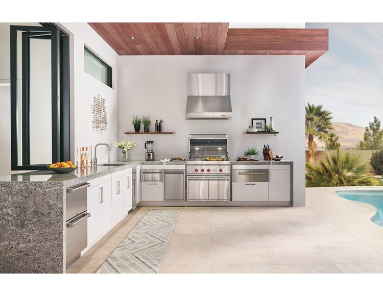 The Wolf 36" Outdoor Gas Grill (OG36) shown with Wolf 30" Outdoor Warming Drawer (WWD30O) in this luxurious poolside outdoor kitchen.