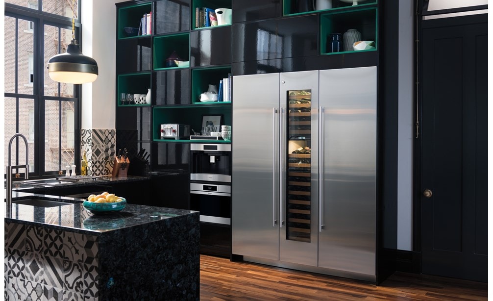 Wolf 24" M Series Contemporary Stainless Steel Steam Oven (CSO2450CM/S) displayed in powerful black cabinetry alongside Volga blue granite countertops