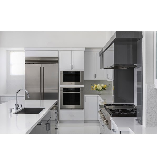 Wolf 30" M Series Transitional Convection Steam Oven (CSO3050TM/S/T) shown in a dimly lit kitchen with glossy white floors and countertops