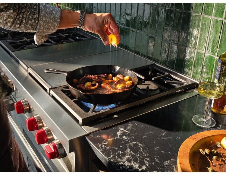 Wolf Dual Fuel Range featured searing lamb chops and sauteing cherry tomatoes with control and finesse