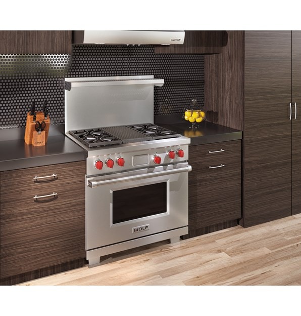 The Wolf 36" Dual Fuel Range 4 Burner Infrared Charbroiler (DF364C) shown delivering state of the art cooking technology in a natural kitchen design.
