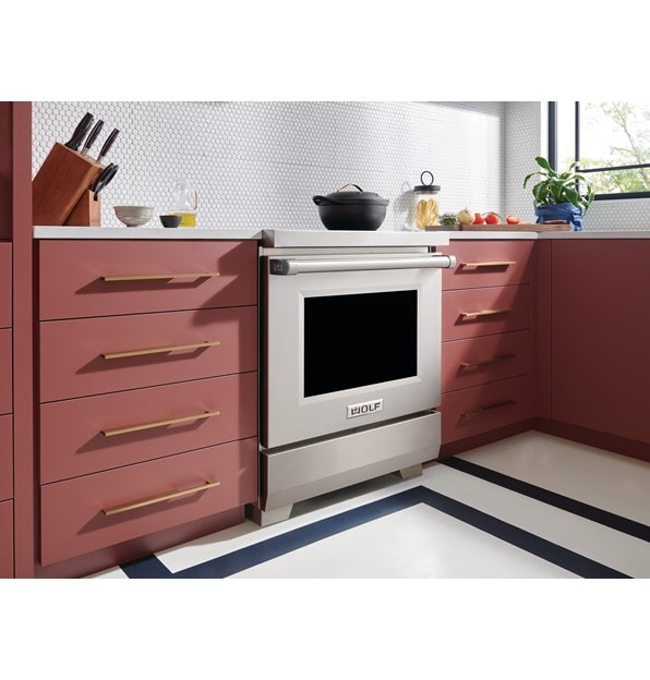 Wolf 30" Professional Induction Range (IR30450/S/P) featured in salmon cabinetry kitchen with a matte black covered pot on its surface.